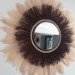 Large wine-coloured raffia mirror and champagne-coloured feathers