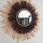 Large wine-coloured raffia mirror and champagne-coloured feathers