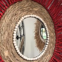 Red raffia mirror on braided base