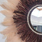 Large wine-coloured raffia mirror and champagne-coloured feathers