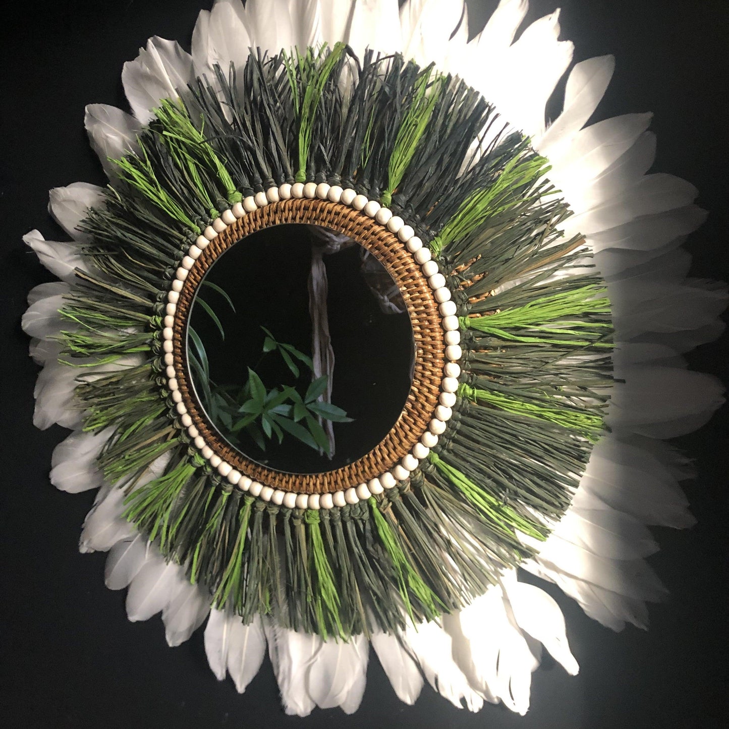 Woody-scented mirror, green raffia and feathers