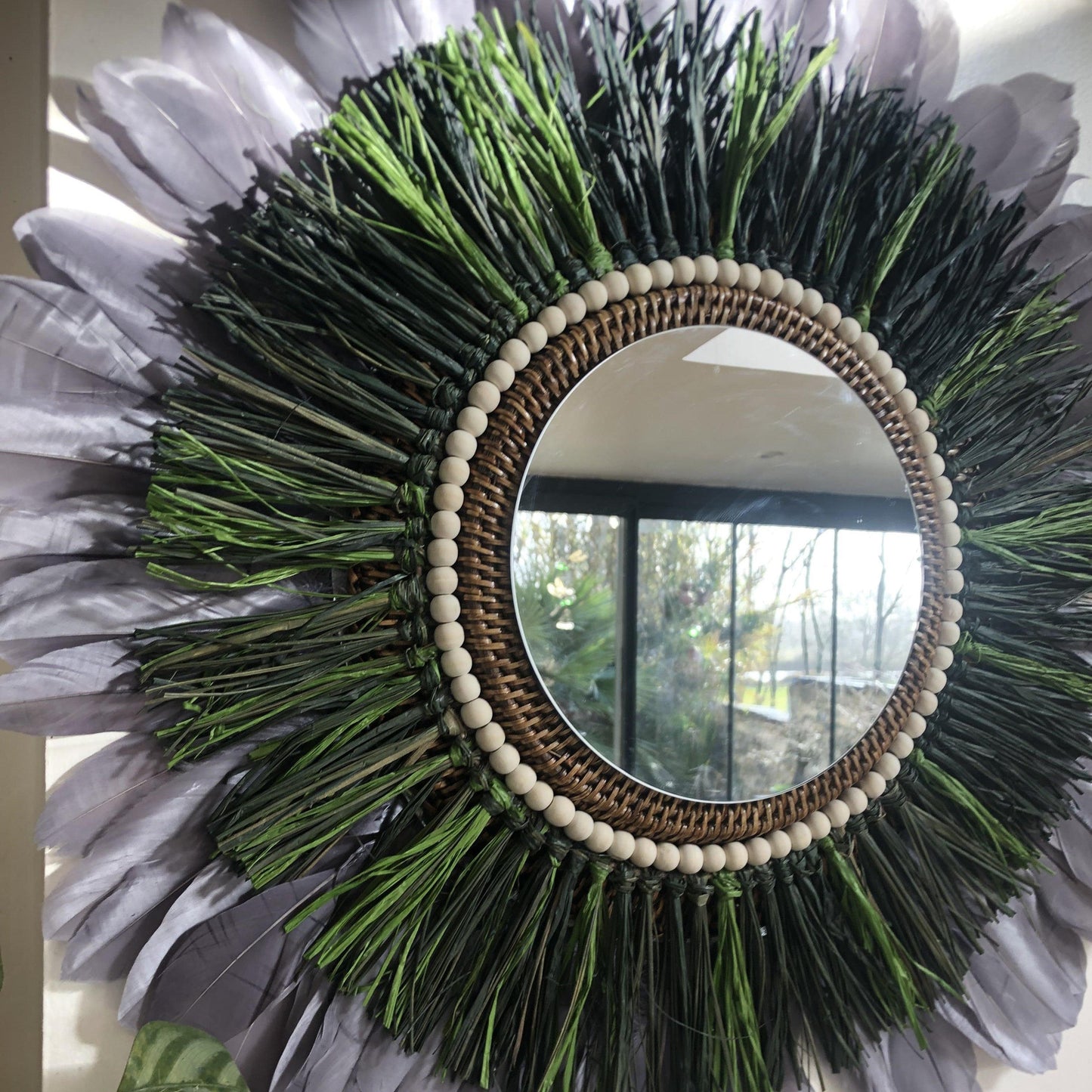 Woody-scented mirror, green raffia and feathers