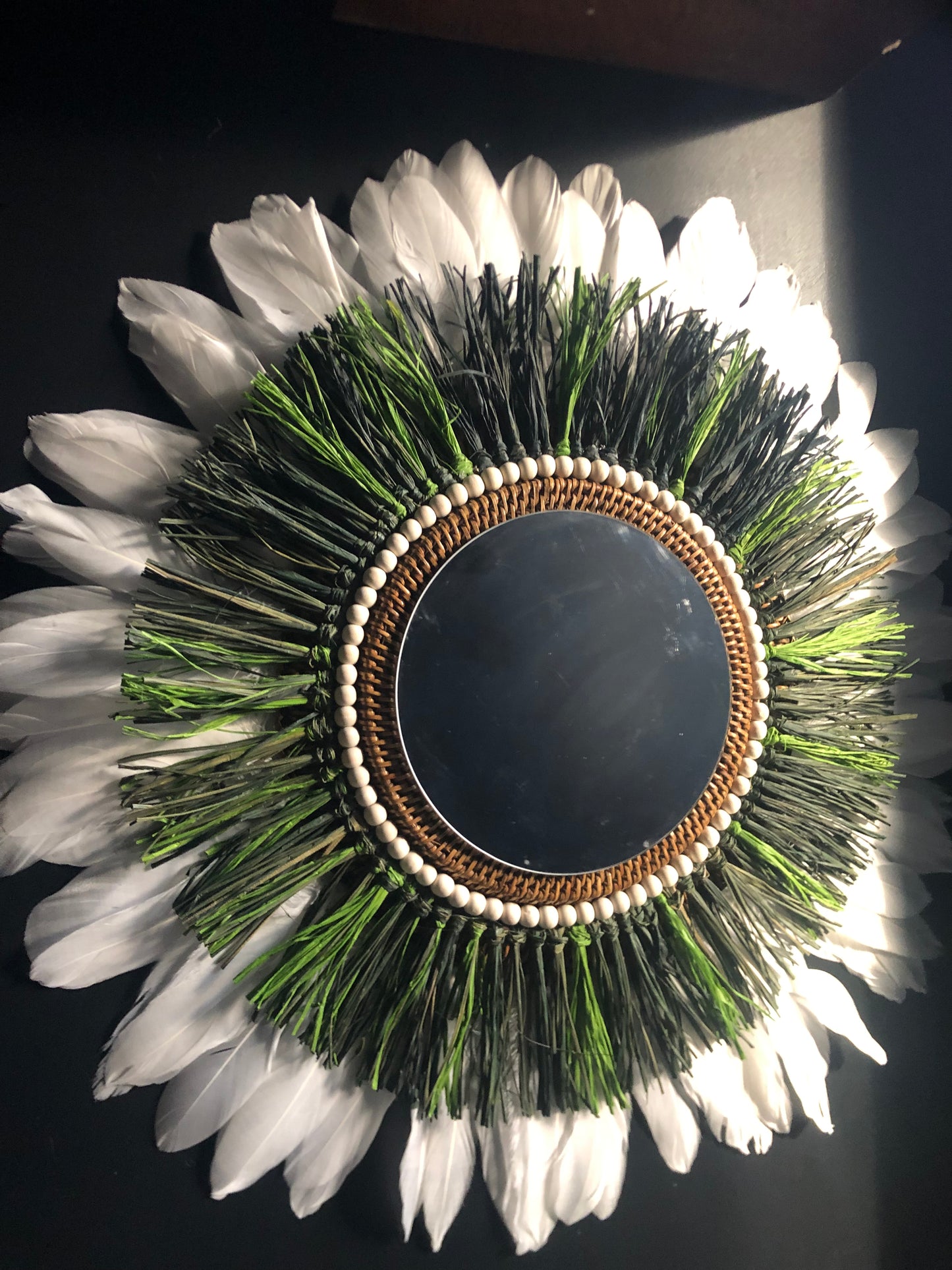 Woody-scented mirror, green raffia and feathers